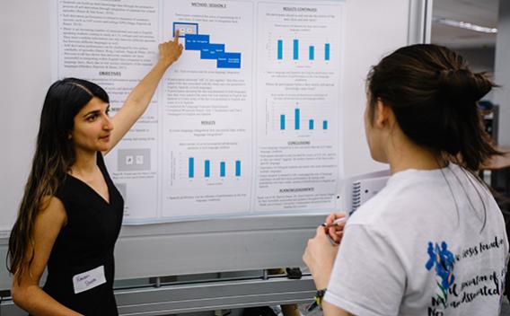 Woman leading viewer through poster presentation